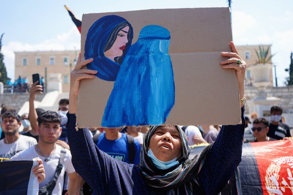 An Afghan woman living in Greece holds a drawing during a protest to raise awareness regarding the situation in Afghanistan.
Athens, Greece, August, 2021.