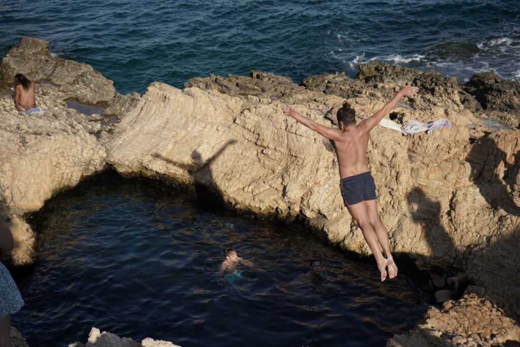 Sunbathers spend time diving into the sea known as "pisina" at Koufonisi island.
According to the legend,this cavity was formed by Poseidon, the God of the sea, as a gift to his beloved Nereids, the sea nymphs, so that they could also be assured of pleasure even when leaving their home deep in the sea.
