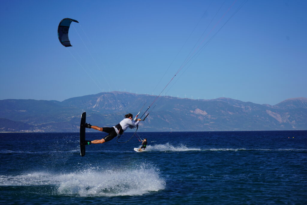 People practising kitesurfing at Drepano beach in West Greece on a sunny summer day. Drepano is famous in the kitesurfing world, for its strong wind.
